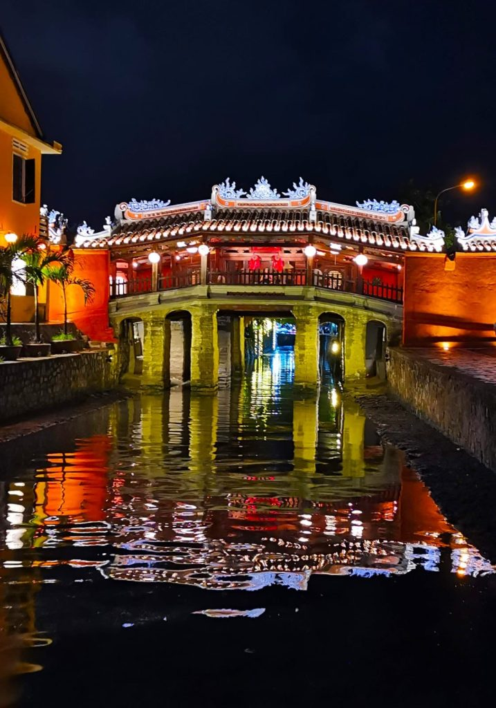 An ancient house or temple lit up at night.