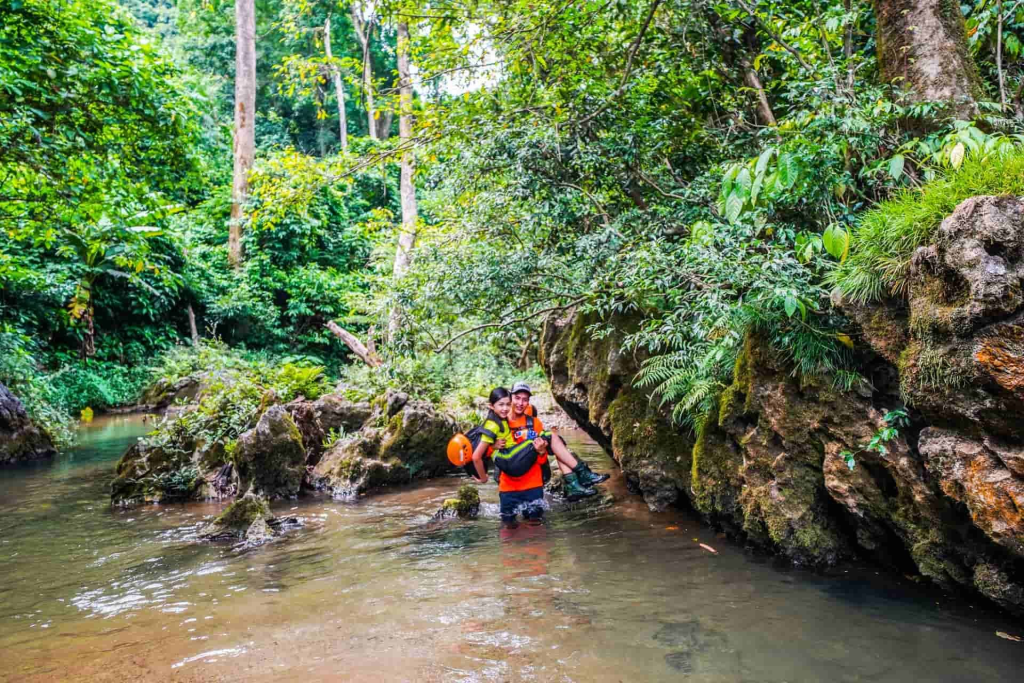 trekking river crossing jungle